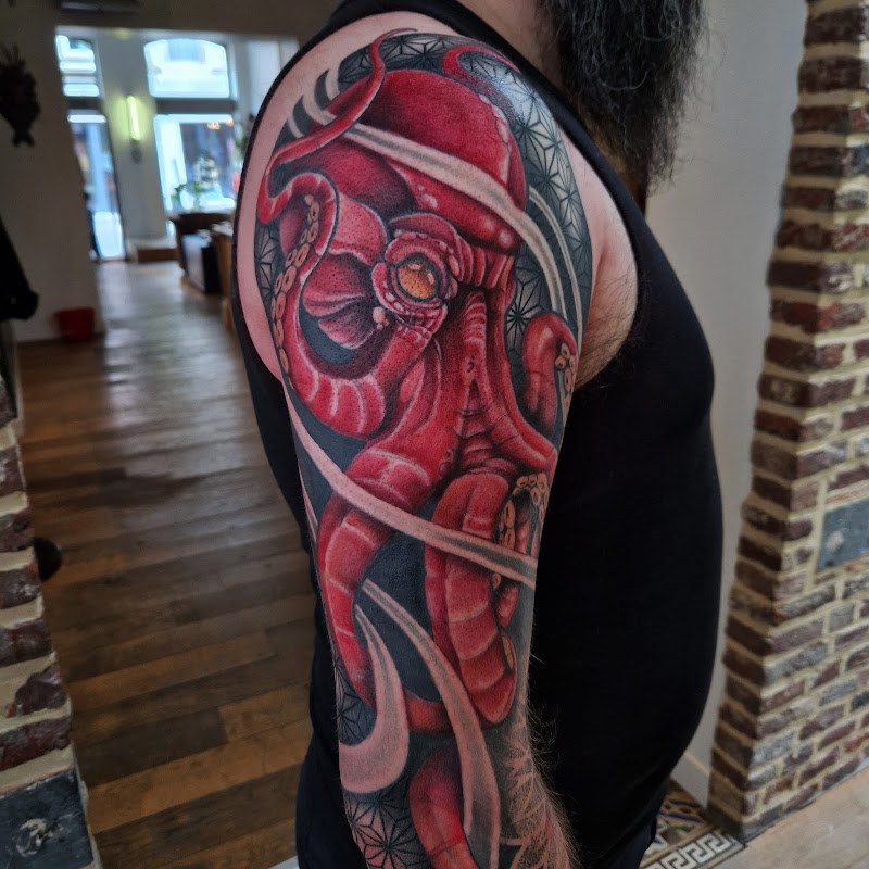 Rode octopus met geometrische patronen op bovenarm.