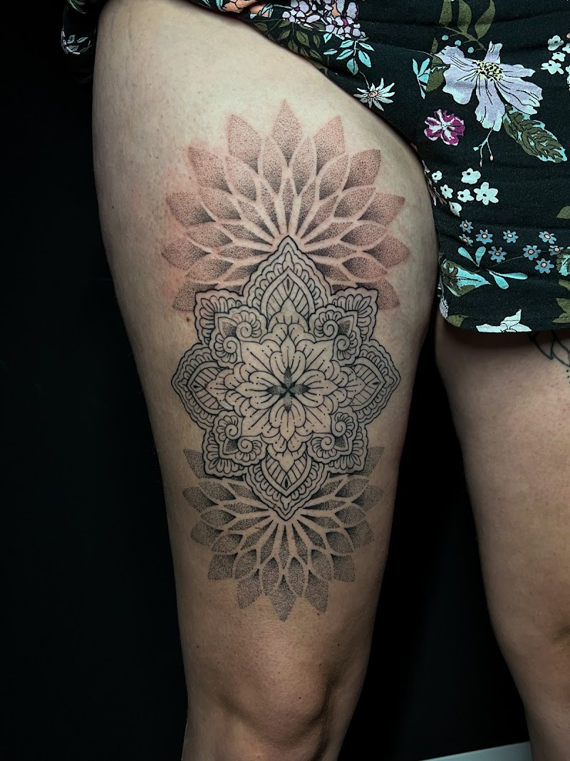 Grote mandala tattoo op bovenbeen met dotwork en lijnwerk.
