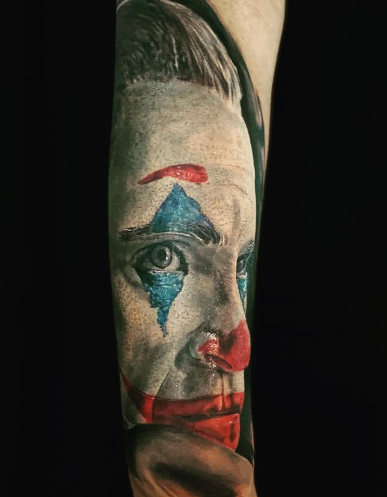 Realistisch portret van de Joker op een onderarm.