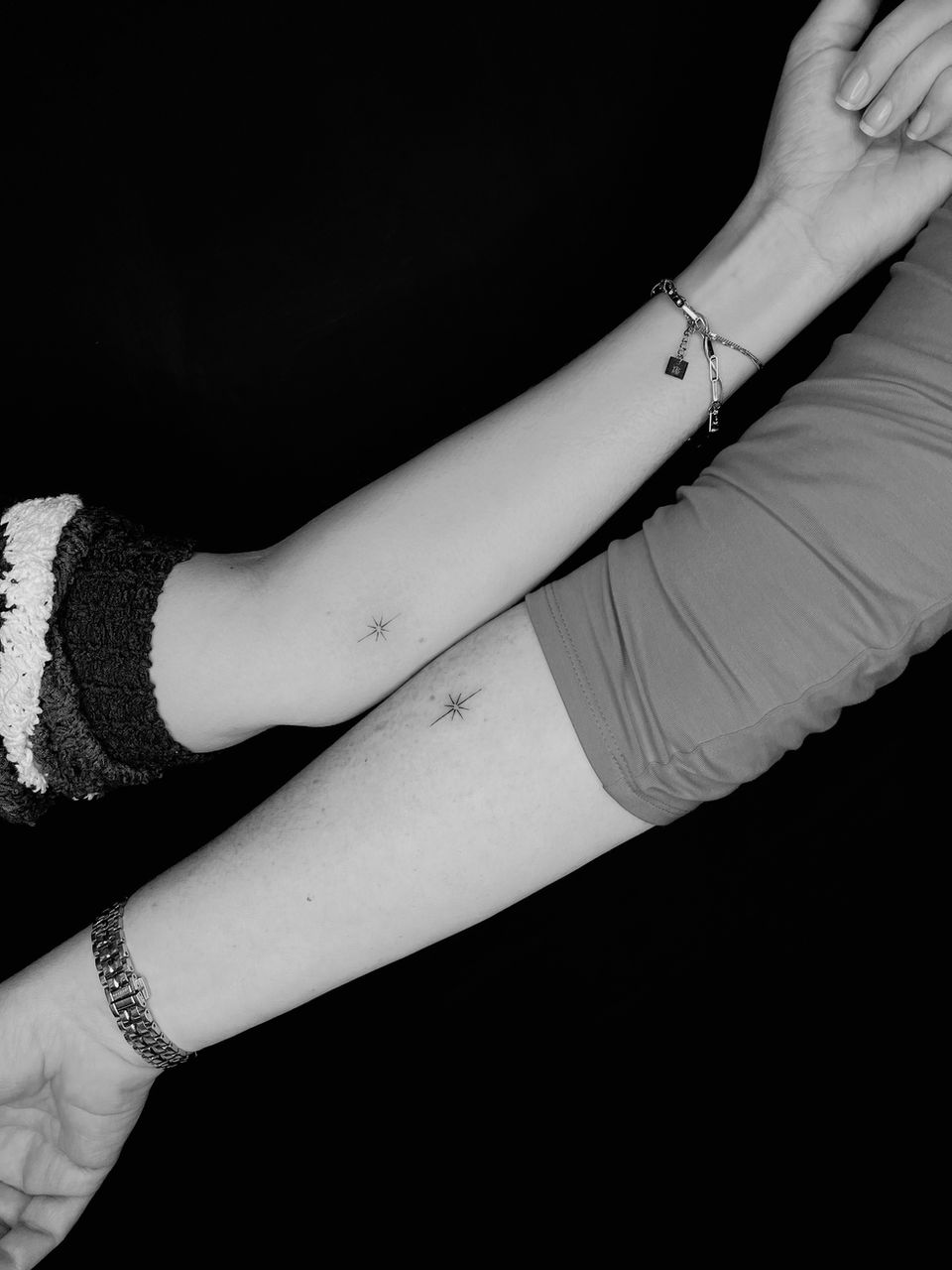 Twee kleine fineline sterretjes op onderarmen.