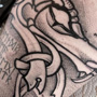 Viking draak en runen in blackwork stijl op de arm.