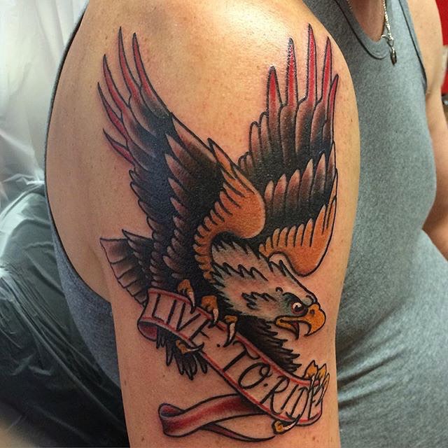 Traditional adelaar met 'LIVE TO RIDE' banner op bovenarm.