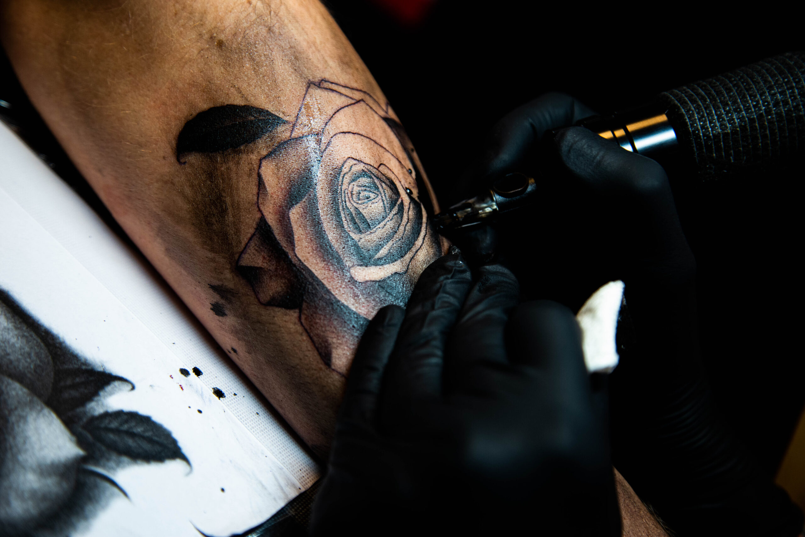Realistische roos tattoo in wording op bovenarm