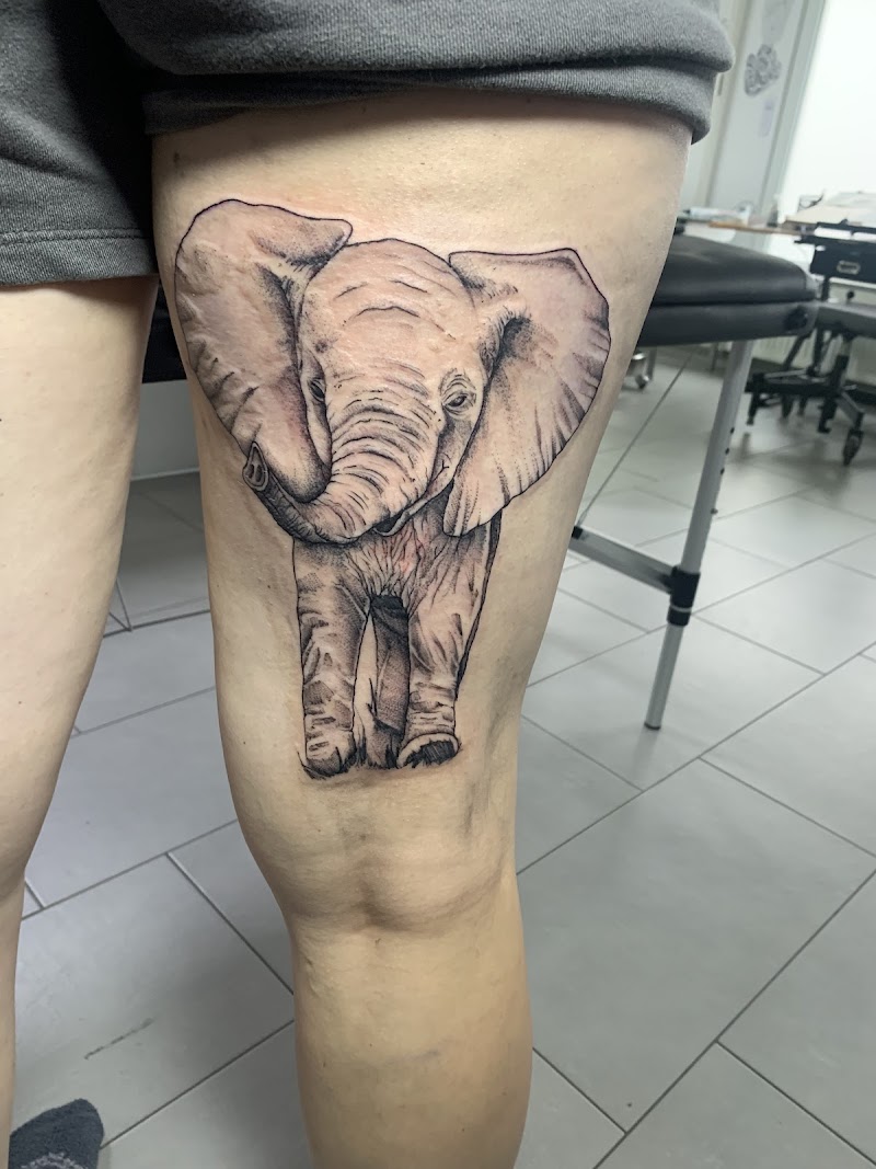 Realistische baby olifant tattoo op bovenbeen.