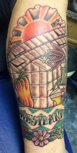 Kleurrijke tattoo met kas, paprika, bier en 'WESTLAND' banner.