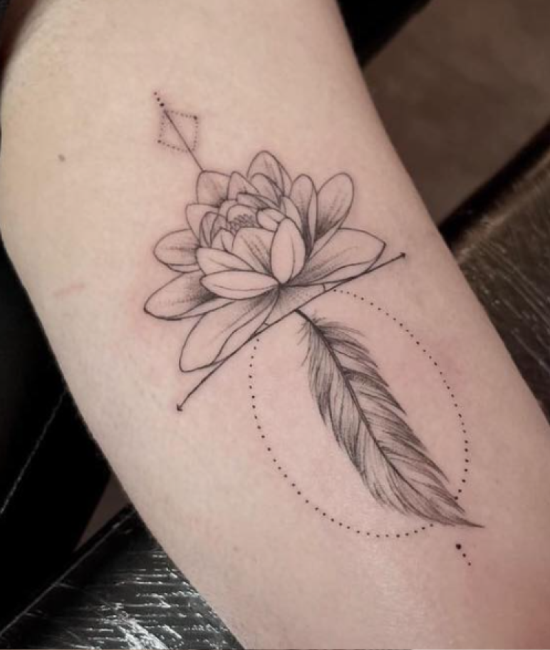 Fineline lotusbloem met veer en geometrische elementen op de bovenarm.